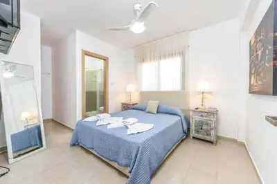 a bedroom with a blue bed with towels on it at Nissi Apartment #101 in Ayia Napa