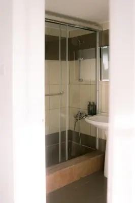 a bathroom with a shower and a sink at Kymo Fig Tree Bay House in Protaras