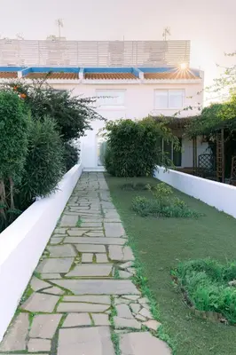 a stone walkway in the yard of a house at Kymo Fig Tree Bay House in Protaras