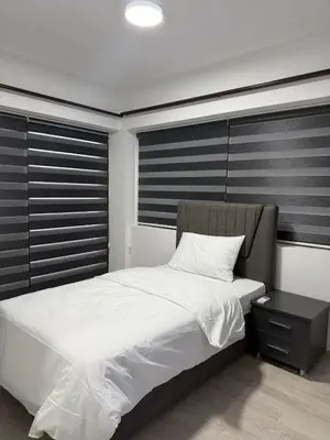 a bedroom with a large white bed and a night stand at Royal Sun Comfortable Villa in Larnaka