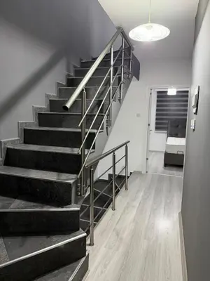 a staircase in a living room with a couch at Royal Sun Comfortable Villa in Larnaka
