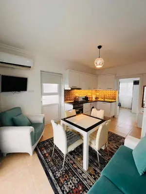 a kitchen and living room with a table and chairs at Royal Sun Comfortable Villa in Larnaka