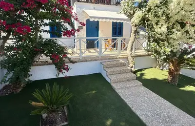 an external view of a house with a yard with flowers at Protaras Sol 2 Bedroom Holiday Let Apartment in Protaras