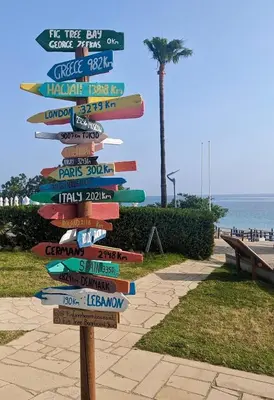 a street sign with many different signs on it at Protaras Sol 2 Bedroom Holiday Let Apartment in Protaras