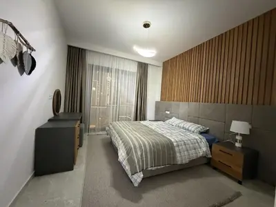 a bedroom with a bed and a dresser and a window at Riverside Life residence in Long Beach, Iskele, North Cyprus in Dherinia