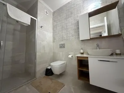 a bathroom with a shower and a toilet and a sink at Riverside Life residence in Long Beach, Iskele, North Cyprus in Dherinia