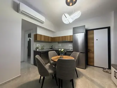 a kitchen with a table and chairs in a room at Riverside Life residence in Long Beach, Iskele, North Cyprus in Dherinia