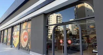a store front with glass doors in a city at Riverside Life residence in Long Beach, Iskele, North Cyprus in Dherinia
