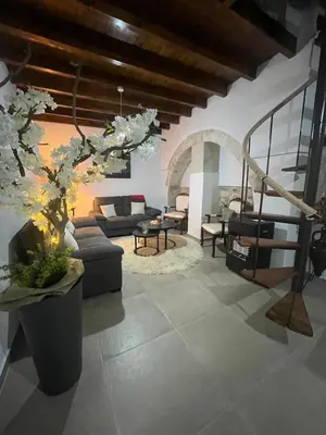 a living room with a couch and a table at Το Αρχοντικόν in Ayvaryara