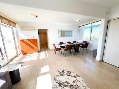 a dining room with a table and chairs at Marina Sea Breeze Apartment, Sleeps 8, Free Wi-Fi in Limassol