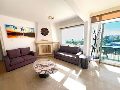 a living room with a couch and a fireplace at Marina Sea Breeze Apartment, Sleeps 8, Free Wi-Fi in Limassol