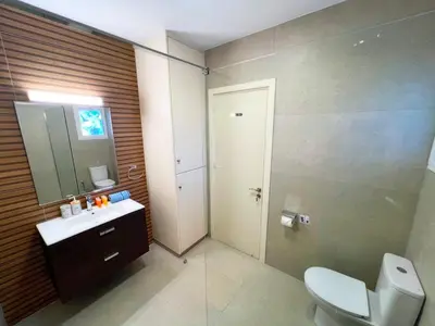 a bathroom with a toilet and a sink and a mirror at Marina Sea Breeze Apartment, Sleeps 8, Free Wi-Fi in Limassol