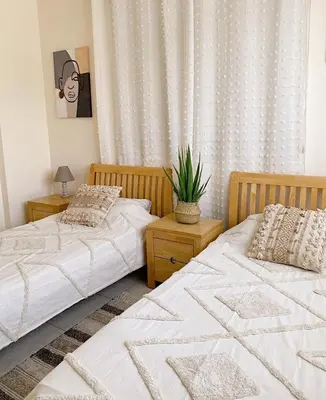 two beds sitting next to each other in a bedroom at NISSI Elena BEACH apt in Ayia Napa