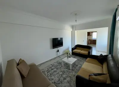 a living room with a couch and a tv at Kyrenia City Center Apartment in Kambia