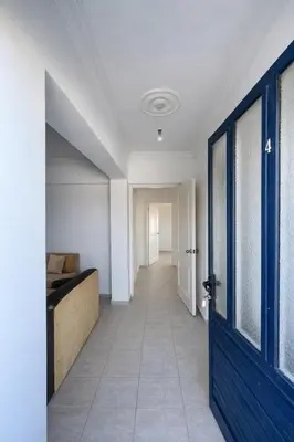 a hallway with a bed and a blue door at Kyrenia City Center Apartment in Kambia