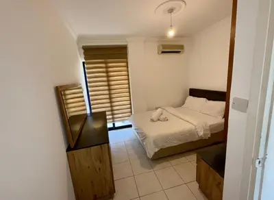a small bedroom with a bed and a window at Kyrenia City Center Apartment in Kambia