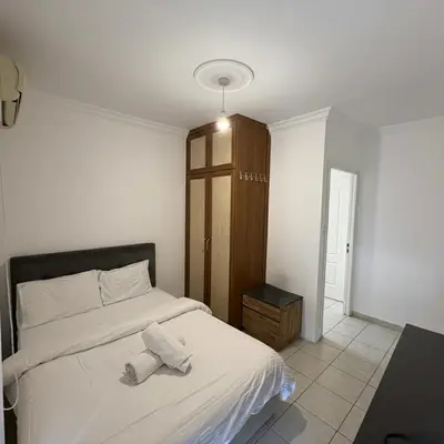a bedroom with a bed with two towels on it at Kyrenia City Center Apartment in Kambia