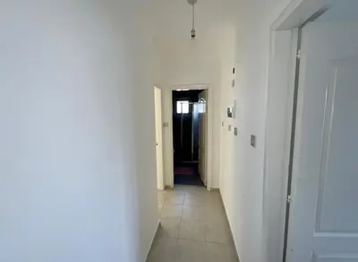 a hallway with white walls and a hallway with a door at Kyrenia City Center Apartment in Kambia
