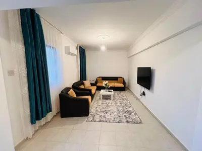 a living room with two couches and a tv at Girne KKTC in Anayia