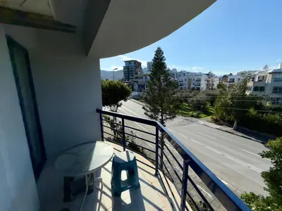 a balcony with a table and a view of a street at Girne KKTC in Anayia