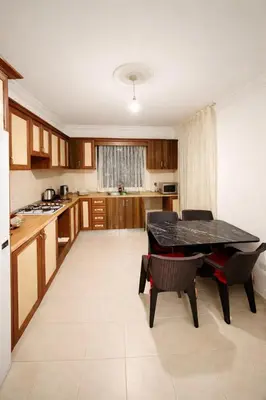 a kitchen with a table and chairs in it at Girne KKTC in Anayia