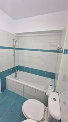 a bathroom with a white toilet and a bath tub at Limassol Great in Limassol