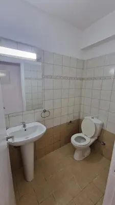 a bathroom with a toilet and a sink at Limassol Great in Limassol