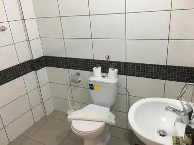 a bathroom with a white toilet and a sink at Flora Maria Hotel in Ayia Napa