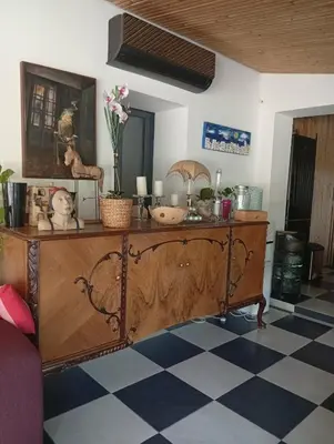 a dresser with flowers on top of it in a room at Ζεν σπίτι in Limassol