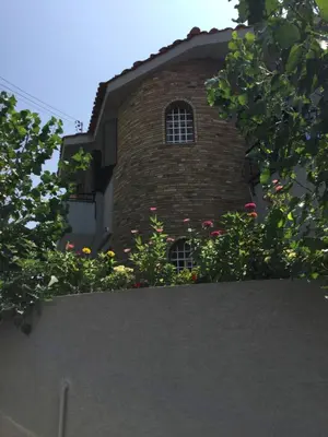 a brick building with flowers in front of it at Nikola's House in Limassol