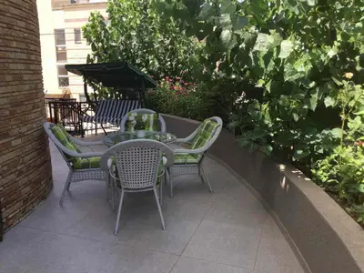 a patio with chairs and a table and umbrella at Nikola's House in Limassol