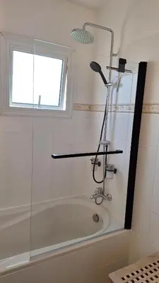 a bathroom with a bath tub with a shower at Nissi Golden Sands Paradi in Ayia Napa