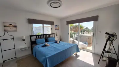 a bedroom with a blue bed and a camera at Nissi Golden Sands Paradi in Ayia Napa