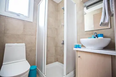 a bathroom with a shower and a toilet and a sink at Seaspray in Protaras