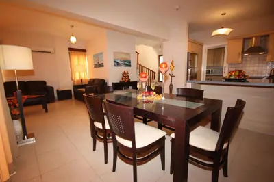 a kitchen and dining room with a table and chairs at Bay Villas in Pissouri