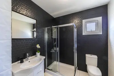 a bathroom with a shower and a toilet and a sink at Protaras Villa Hollywood in Protaras