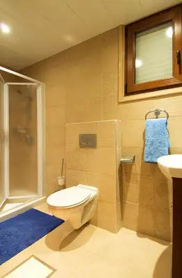 a bathroom with a toilet and a shower and a sink at Ithaki Phinikoudes Apartment 307 in Larnaka