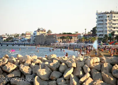 a group of people in the water at a beach at Ithaki Phinikoudes Apartment 307 in Larnaka