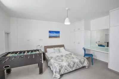 a bedroom with a bed and a table in a room at Greco Villas in Protaras