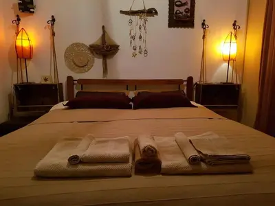 a bedroom with a bed with towels on it at Aquarian Beachfront Apartment in Larnaka