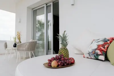 a plate of fruit on a white table in a room at At Herbal Boutique Hotel & Spa in Protaras