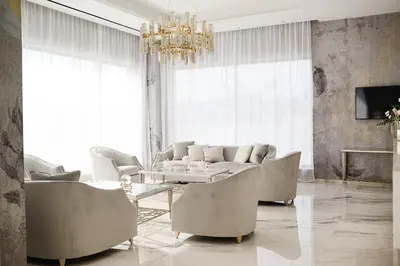 a living room with a couch and chairs and a chandelier at At Herbal Boutique Hotel & Spa in Protaras