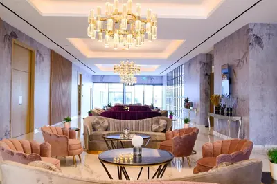 a lobby with chairs and tables and a chandelier at At Herbal Boutique Hotel & Spa in Protaras