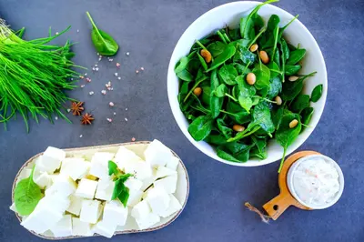 a bowl of spinach and a bowl of tofu and a salad at At Herbal Boutique Hotel & Spa in Protaras