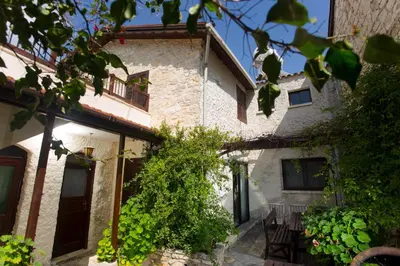 an external view of a house with plants at The Old Olive Mill House by TrulyCyprus in Doros
