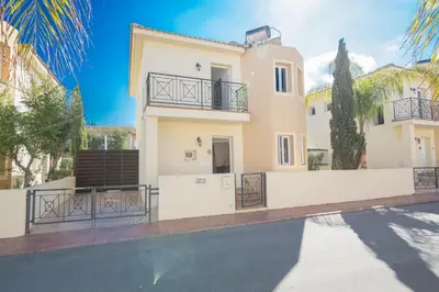 a villa with a swimming pool in front of a house at Nancy Villas in Protaras