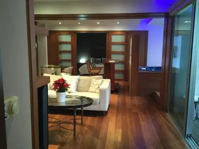 a living room with a white couch and a table at Sofouli Suites in Nicosia