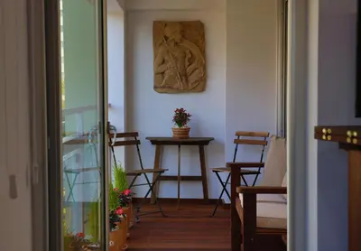 a room with a table with chairs and a sculpture on the wall at Sofouli Suites in Nicosia