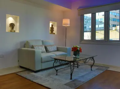 a living room with a couch and a coffee table at Sofouli Suites in Nicosia