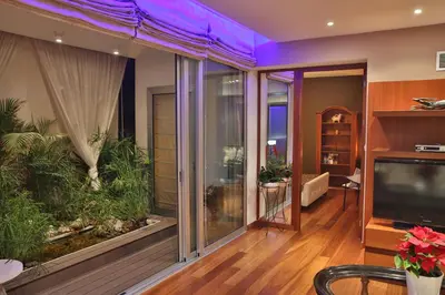 a living room with a large window with a aquarium at Sofouli Suites in Nicosia